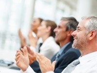 Group of happy business people clapping their hands